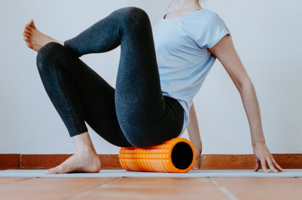 WomanDoingGluteMyofascialReleaseOnFoamRoller - HQZ Foam Rollers