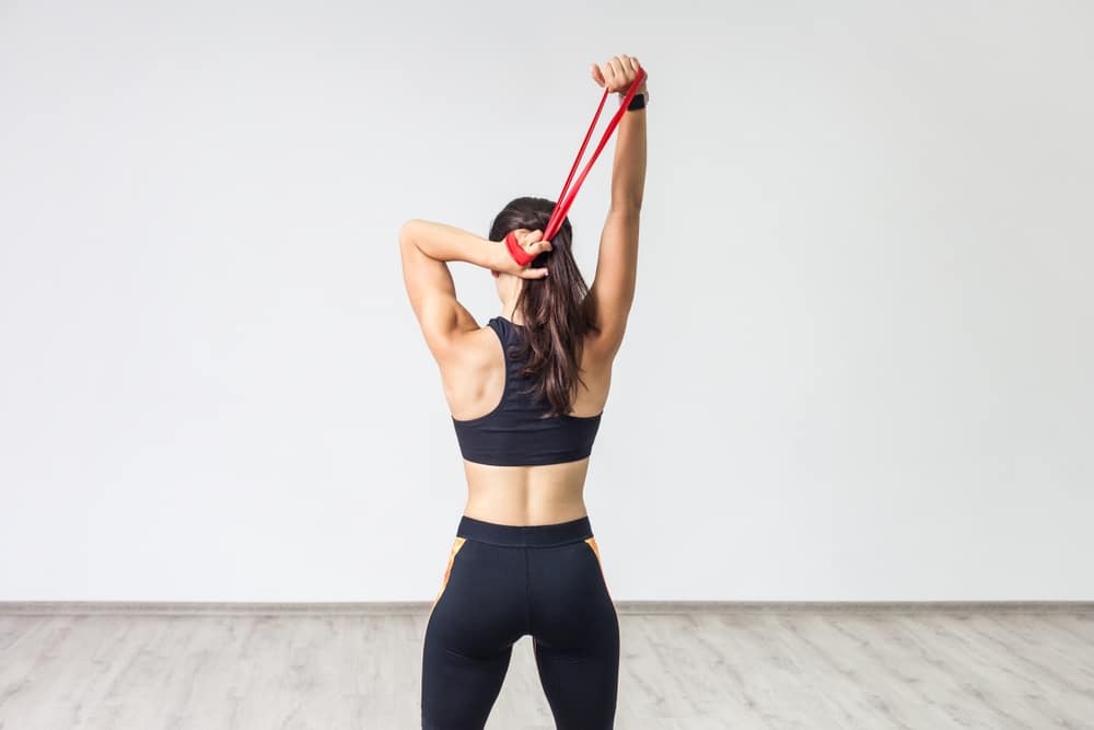 BackViewOfYoungSportyWomanWearingBlackTankTop - HQZ Resistance Bands
