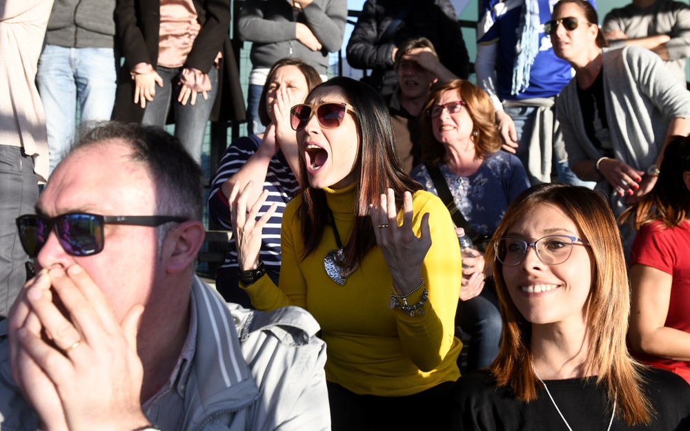 MILAN, ITALY-MARCH 16, 2019: parents following and supporting, a kids soccer match on tribune, in Milan.